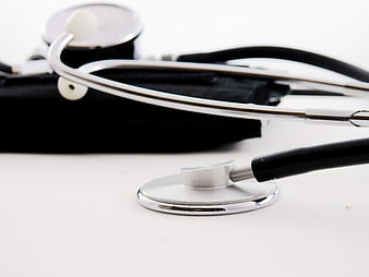 Close-up of stethoscope and blood pressure cuff on white background