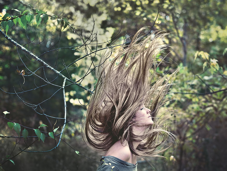 Woman with long hair blowing in the wind outdoors