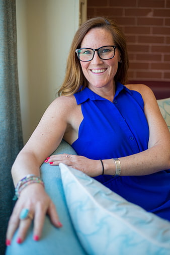 Smiling Business Woman in Blue Dress with Glasses