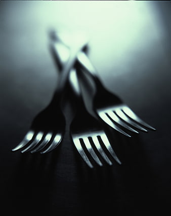Dramatic Black and White Photo of Three Crossed Forks