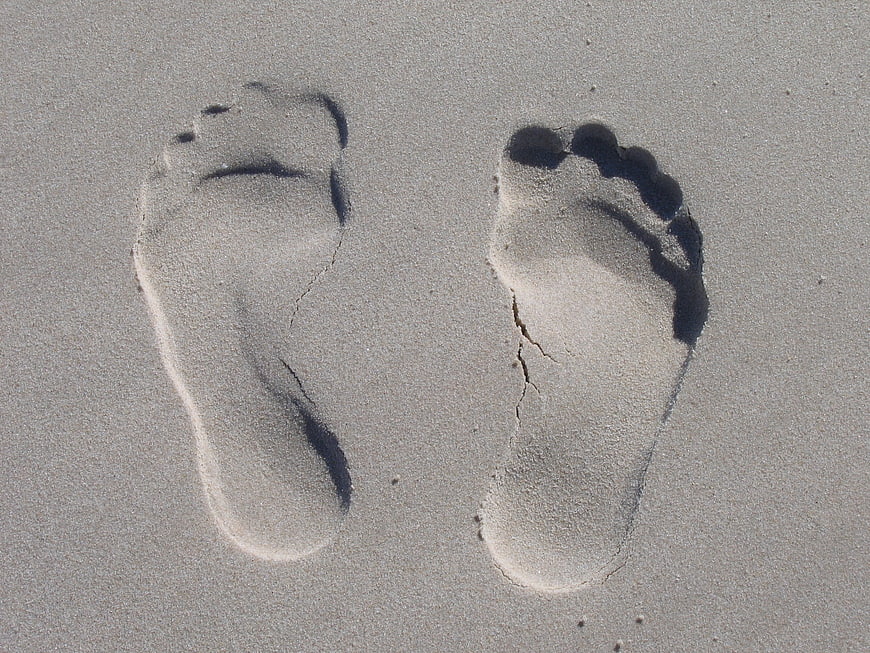 Footprints in the sand on a sunny beach