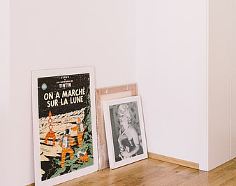 Vintage Tintin and Marilyn Monroe Posters Leaning Against White Wall
