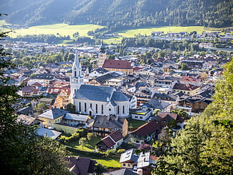 Panoramic View of Austrian Town with White Church and Mountains