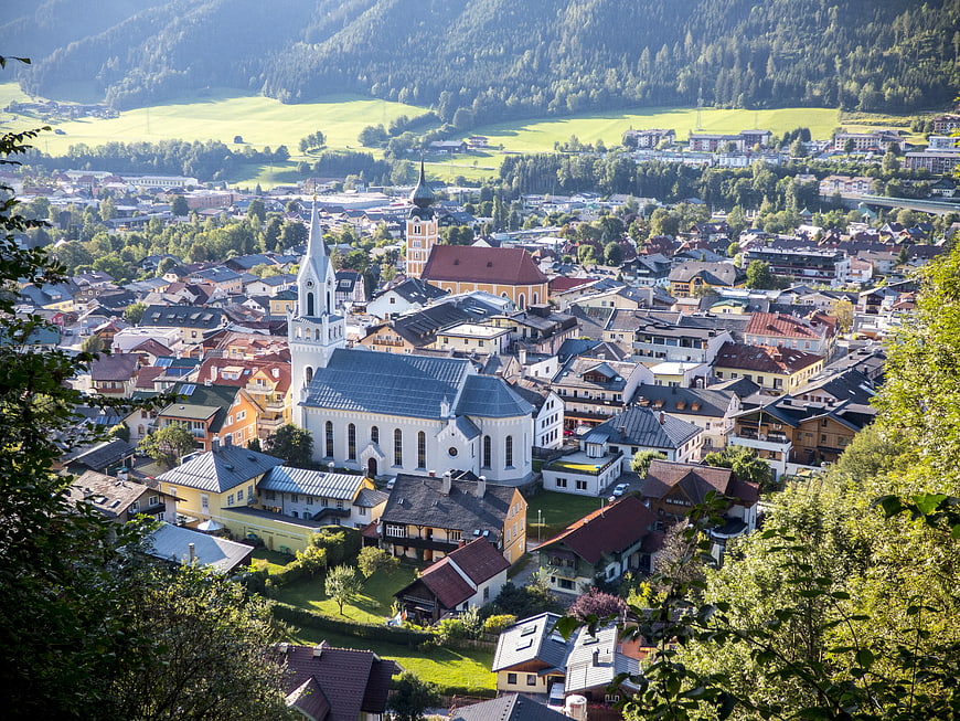 Panoramic View of Austrian Town with White Church and Mountains
