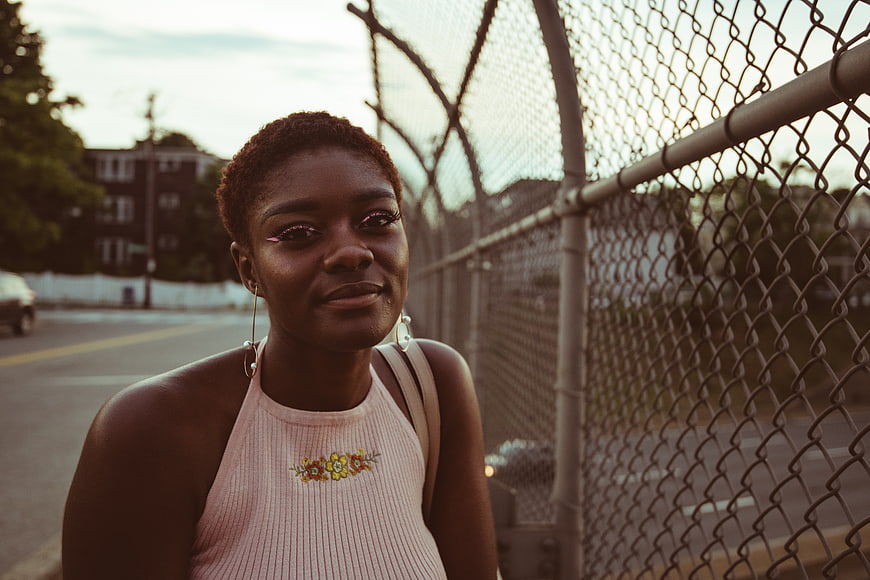 Stylish Black Woman Portrait by Chain Link Fence
