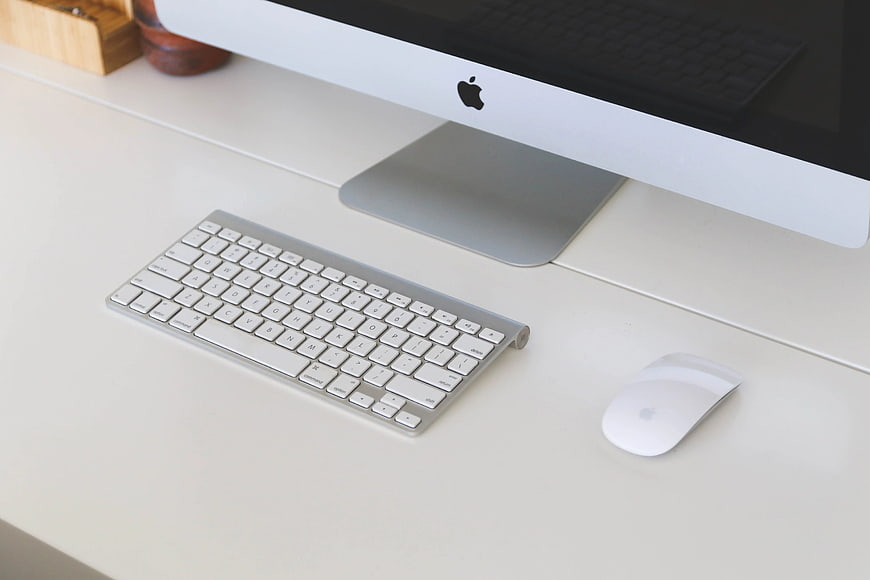 Minimalist Apple iMac Workspace on White Desk
