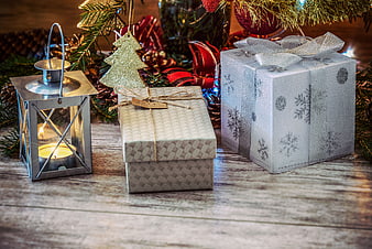 Christmas gifts and lantern on rustic wooden table