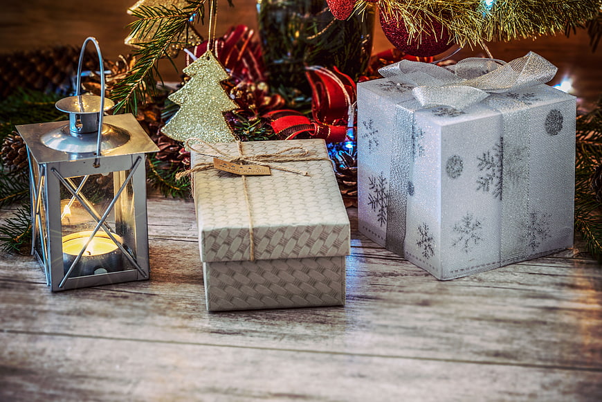Christmas gifts and lantern on rustic wooden table