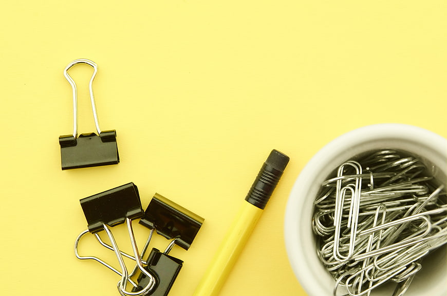 Yellow Office Supplies Flat Lay with Binder Clips and Paperclips