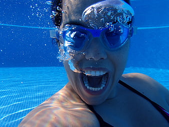 Underwater Close-Up Of Woman Screaming In Swimming Pool