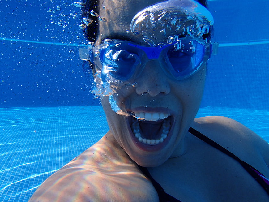 Underwater Close-Up Of Woman Screaming In Swimming Pool