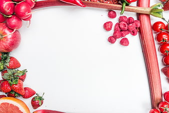 Red fruits and vegetables border on white background