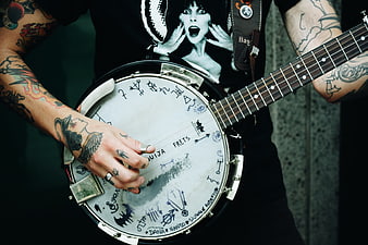 Tattooed Musician Playing Custom Decorated Banjo