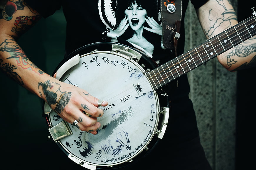 Tattooed Musician Playing Custom Decorated Banjo