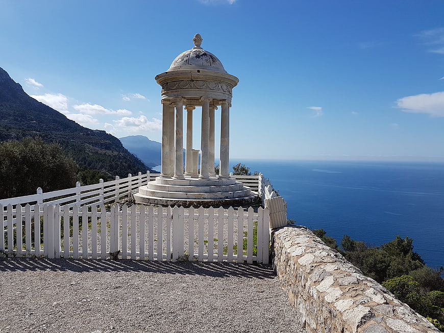 White marble temple overlooking the blue sea and mountains