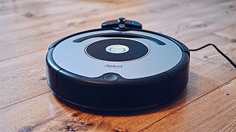 iRobot Roomba robotic vacuum cleaner on wooden floor