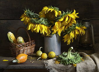 Rustic autumn still life with sunflowers, corn, and pumpkins