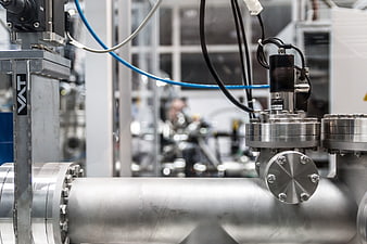 Close-up of industrial stainless steel pipes and valves in a factory