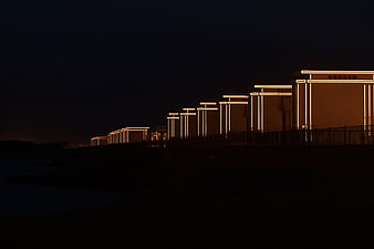 Modern illuminated architecture at night with warm lights