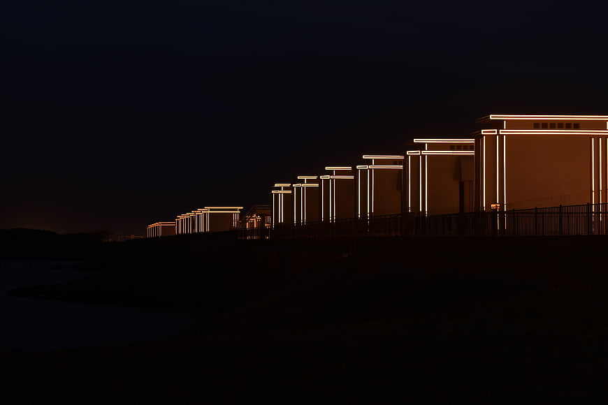 Modern illuminated architecture at night with warm lights