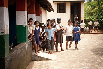 Group of Indian school children standing in courtyard