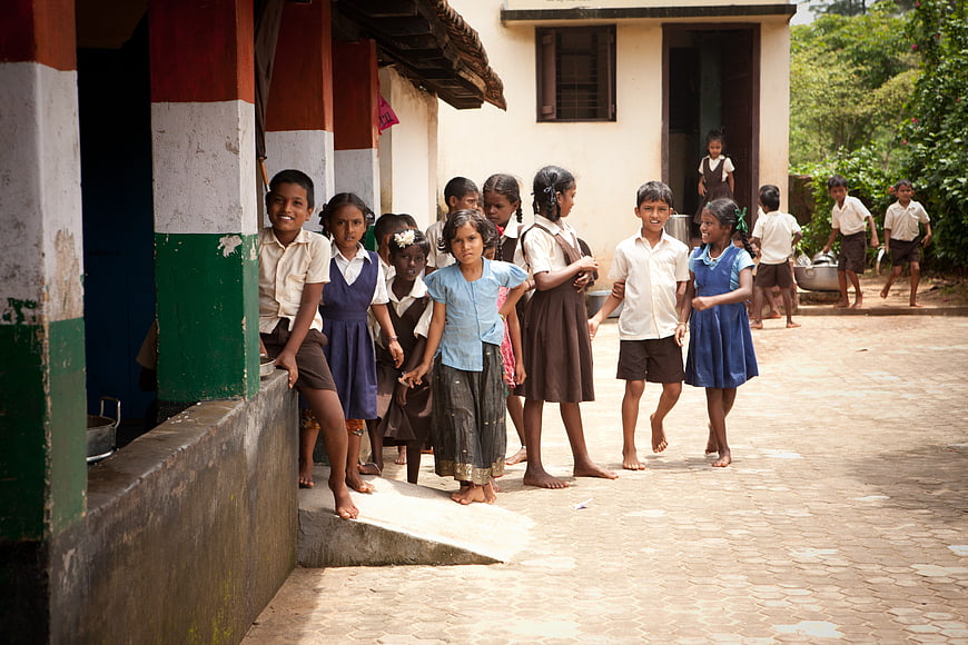 Group of Indian school children standing in courtyard