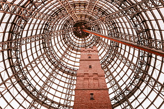 Low angle view of brick tower inside glass dome