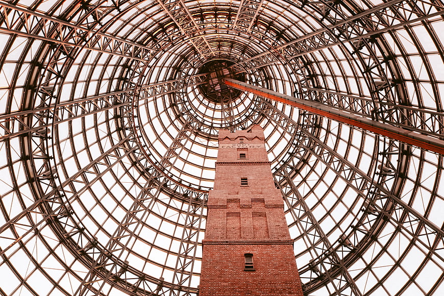 Low angle view of brick tower inside glass dome