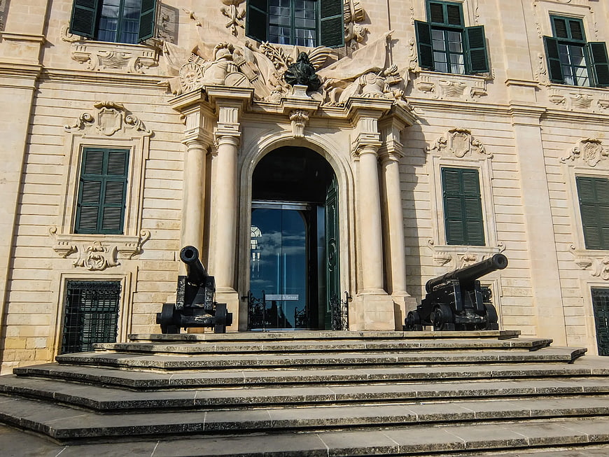Historic Baroque Building Entrance with Cannons
