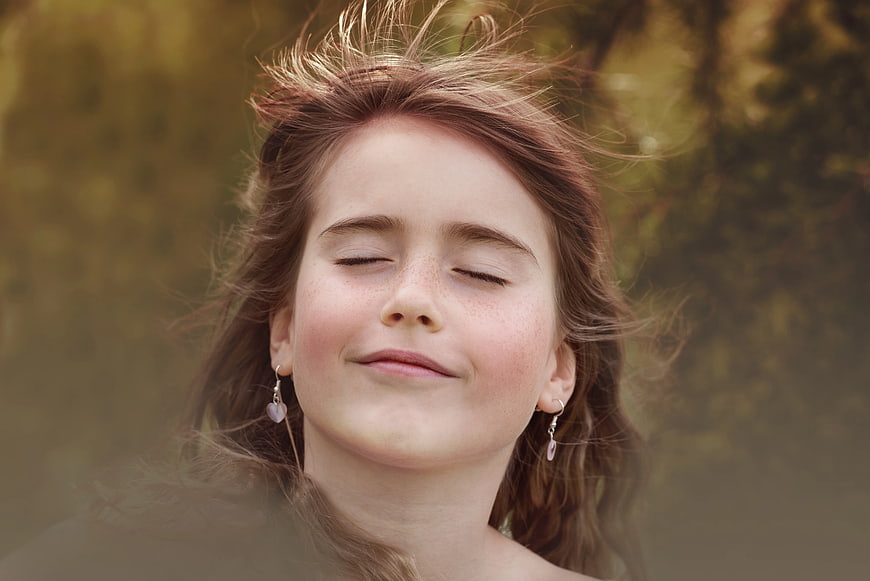 Serene Girl with Eyes Closed in Golden Light