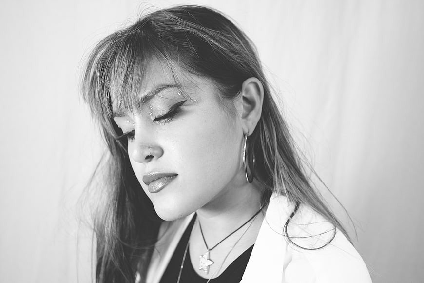 Black and white portrait of a young woman with closed eyes
