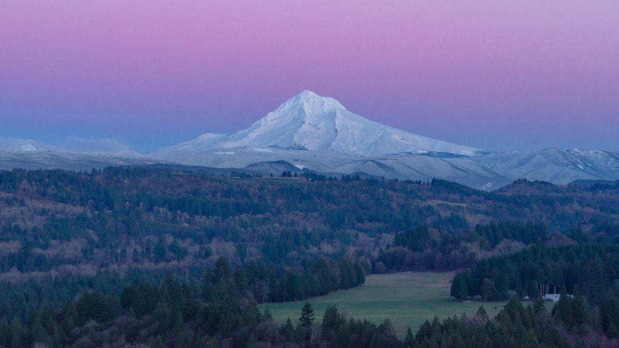 Snow-Capped Mountain Peak Against Purple Twilight Sky