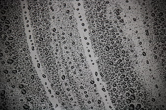 Close-up of water droplets on a wet glass window surface