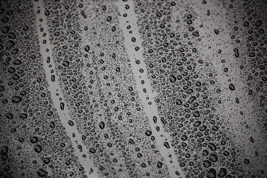 Close-up of water droplets on a wet glass window surface