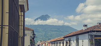 Colonial street view with mountain backdrop and blue sky