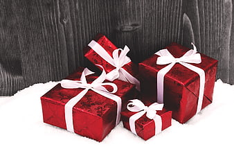 Red Christmas Gift Boxes With White Ribbons On Snow
