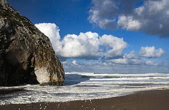 Dramatic coastal landscape with rocky cliff and ocean waves