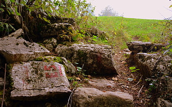 Hiking trail with red E5 marker on rocks in Lessinia, Italy