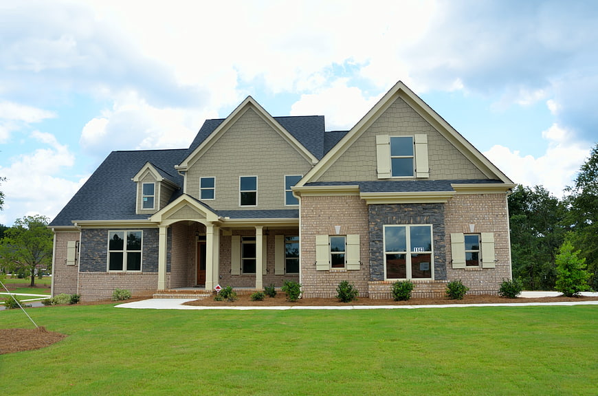 Modern suburban two-story house with brick and siding exterior