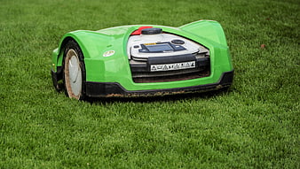 Green Robotic Lawn Mower Operating On Lush Green Grass