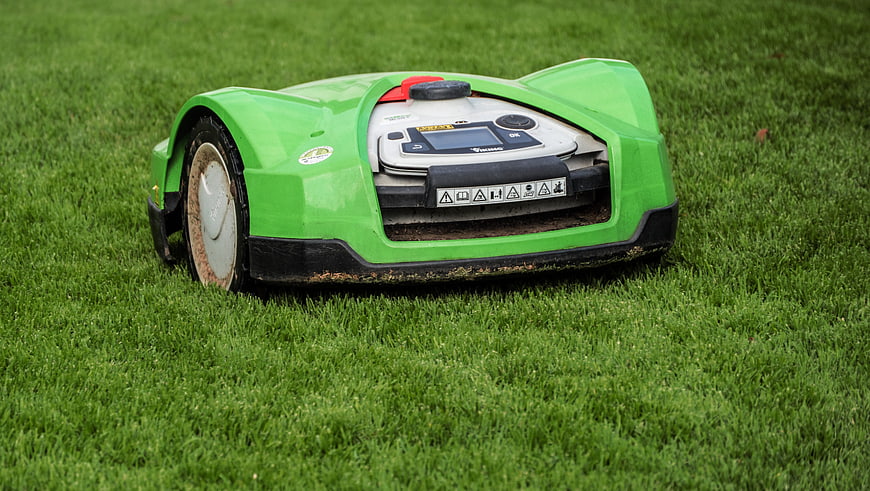 Green Robotic Lawn Mower Operating On Lush Green Grass