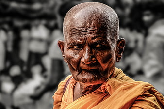 Portrait of elderly Buddhist monk with wrinkled face