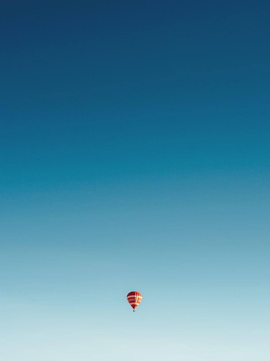 Minimalist Hot Air Balloon Against Blue Gradient Sky