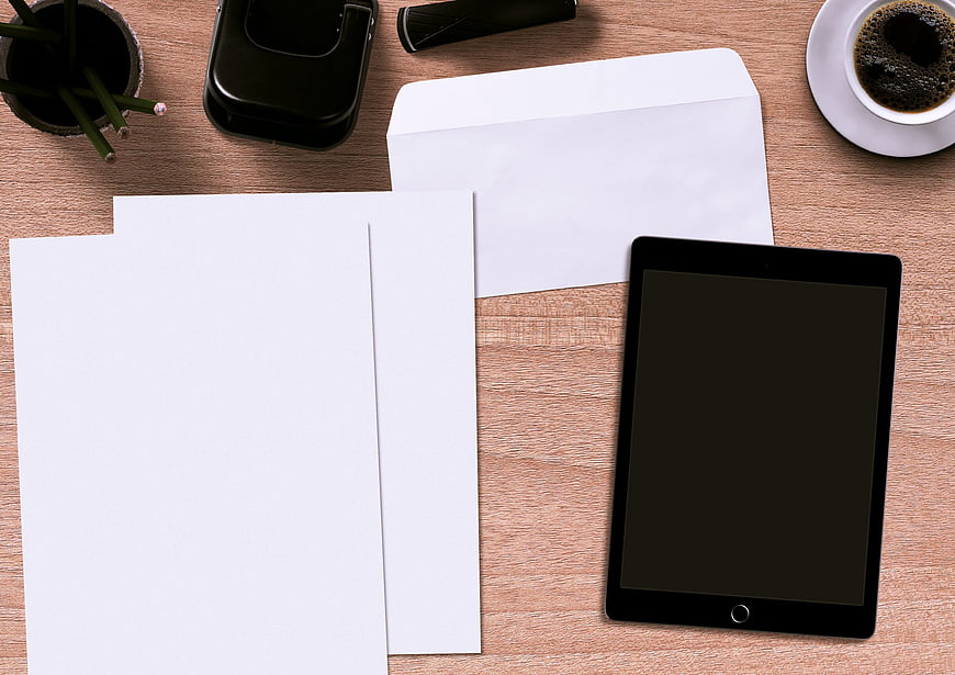 Top View Office Desk With Tablet, Envelope, Paper, Coffee, And Stationery