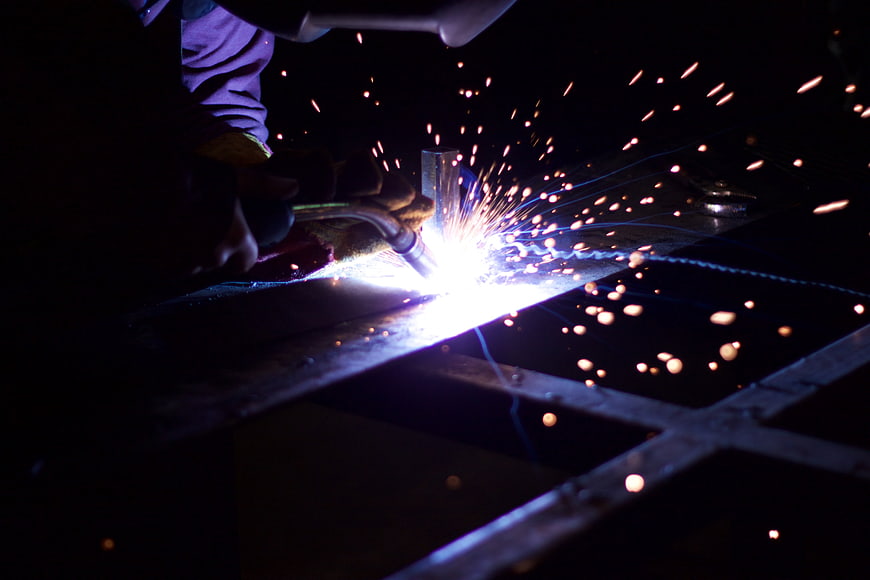 Close-up of Welder Creating Sparks on Metal Frame