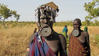 Mursi women with lip plates in Ethiopian savanna