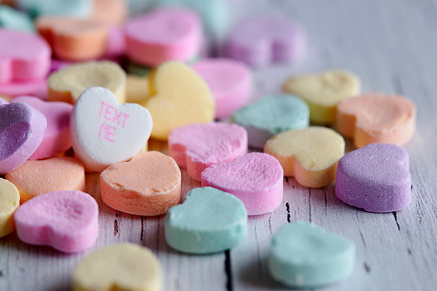 Colorful Heart Shaped Conversation Candies on Wooden Background