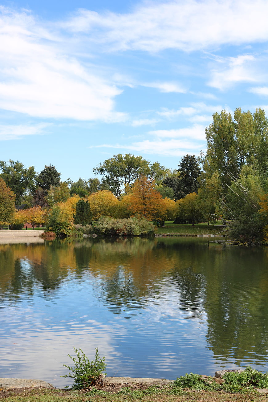 Serene Autumn Lake with Colorful Trees and Blue Sky
