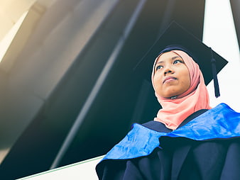 Female Graduate in Hijab Looking Up at University