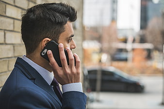 Businessman in Suit Talking on Smartphone Outdoors